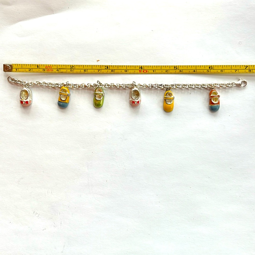 Beautiful enamel and sterling silver baby shoe charm bracelet 7” long
